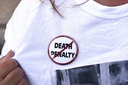 275634 An anti-death penalty button is worn by a demonstrator attending a protest against the scheduled execution of convicted mu